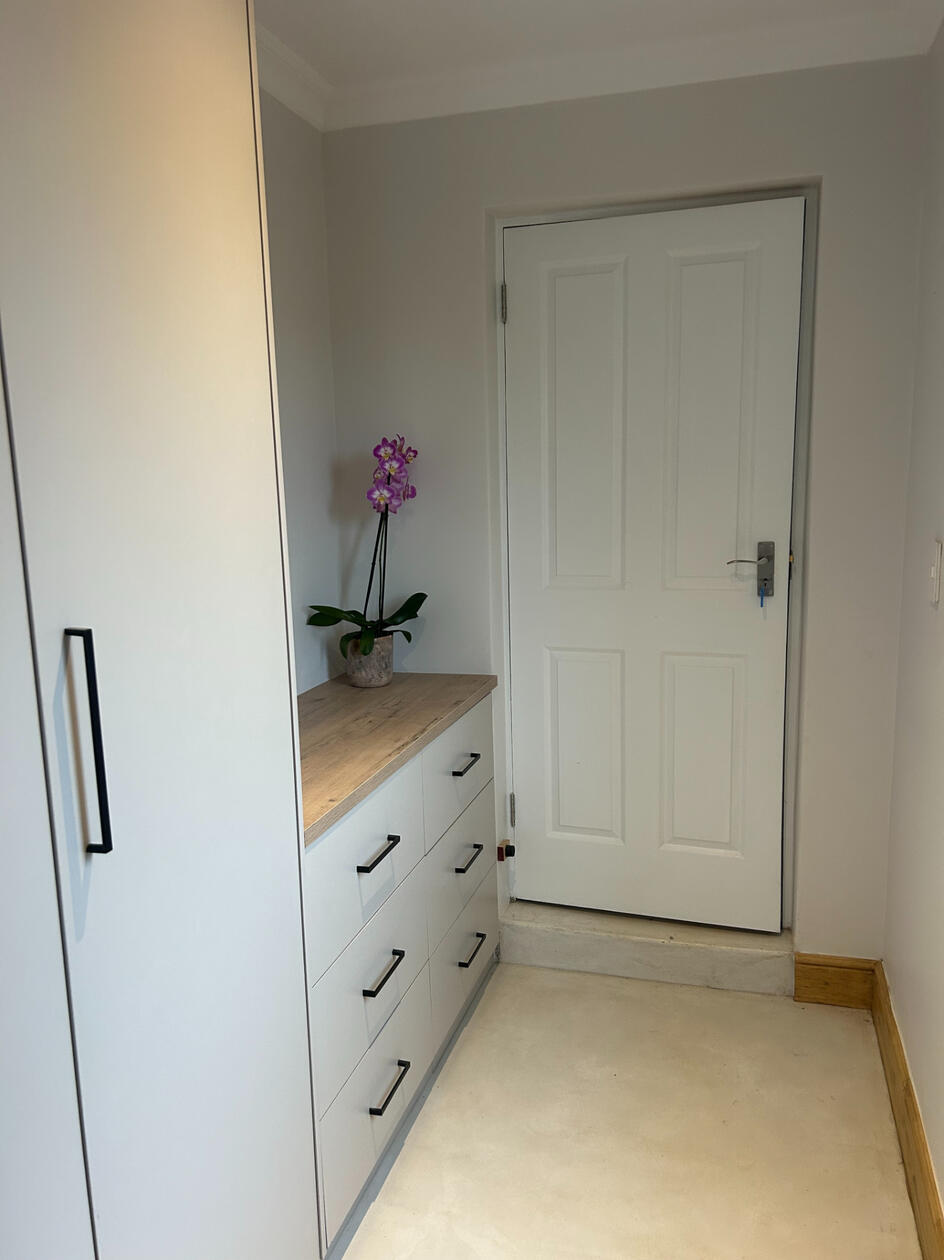 Main Bedroom Entryway Drawers help organise this bedroom.
